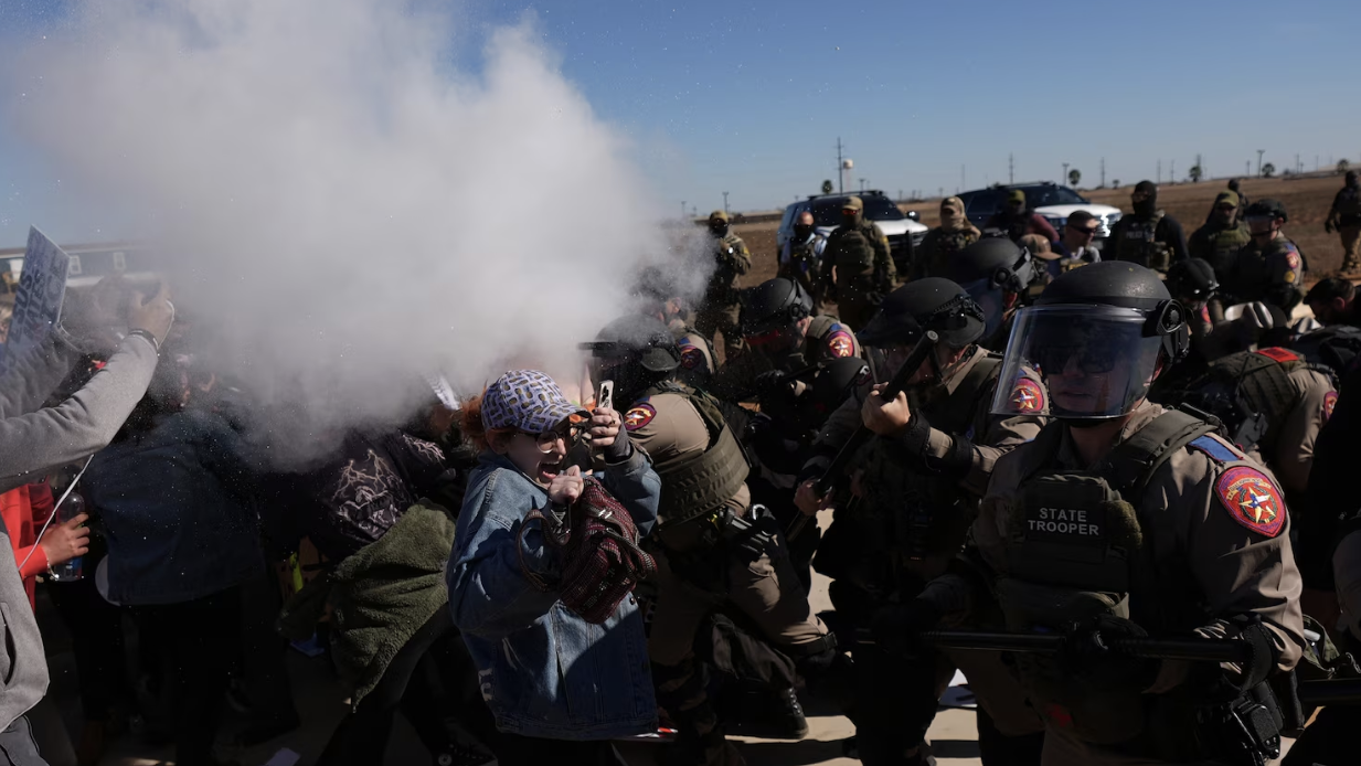 Police tear gassing people protesting at the Dilley Detention Center in Texas